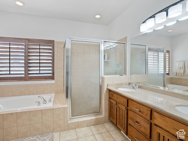 Bathroom with plus walk in shower, tile flooring, dual sinks, and vanity with extensive cabinet space