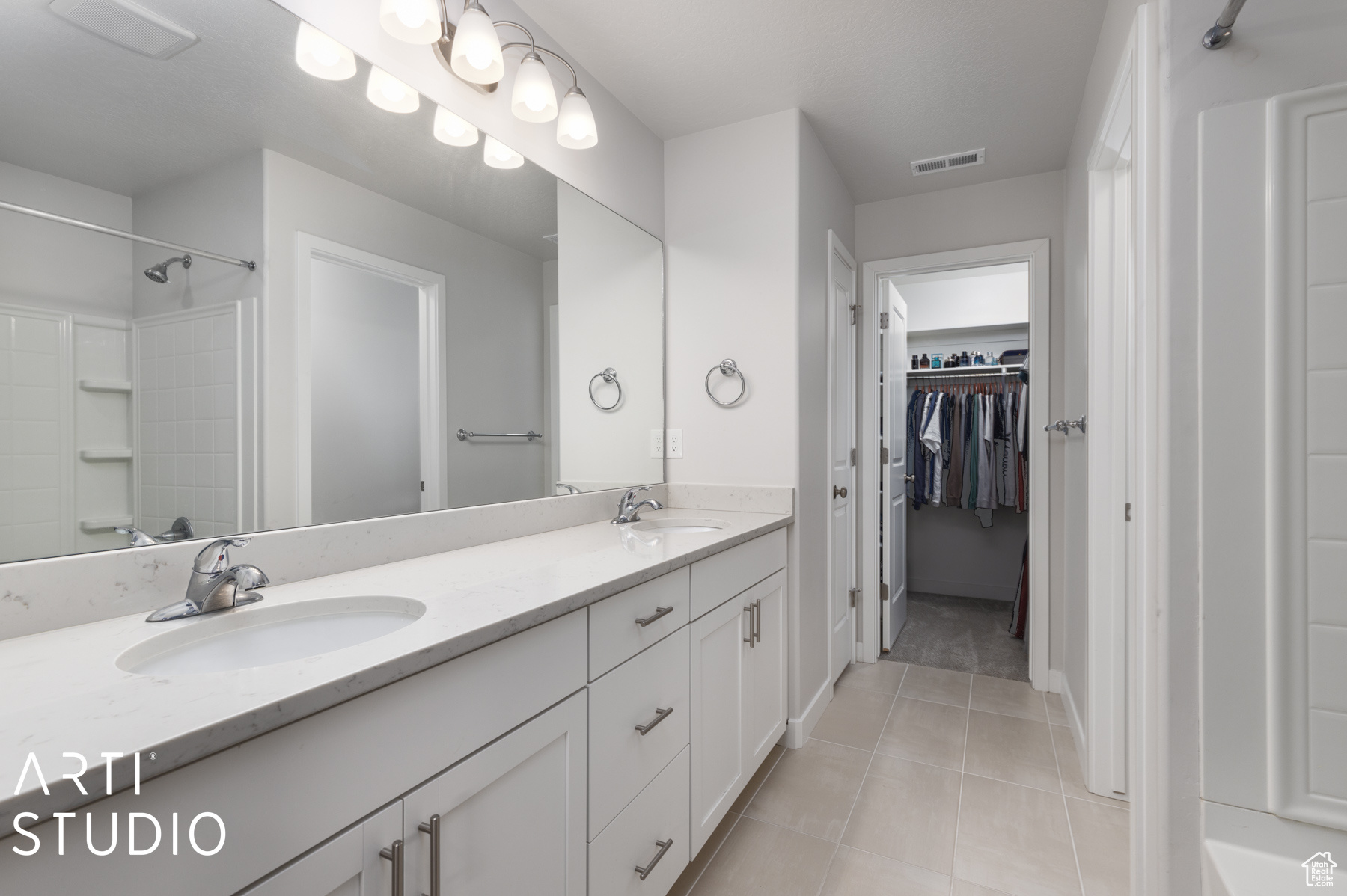 Bathroom with double sink, tile floors, and oversized vanity