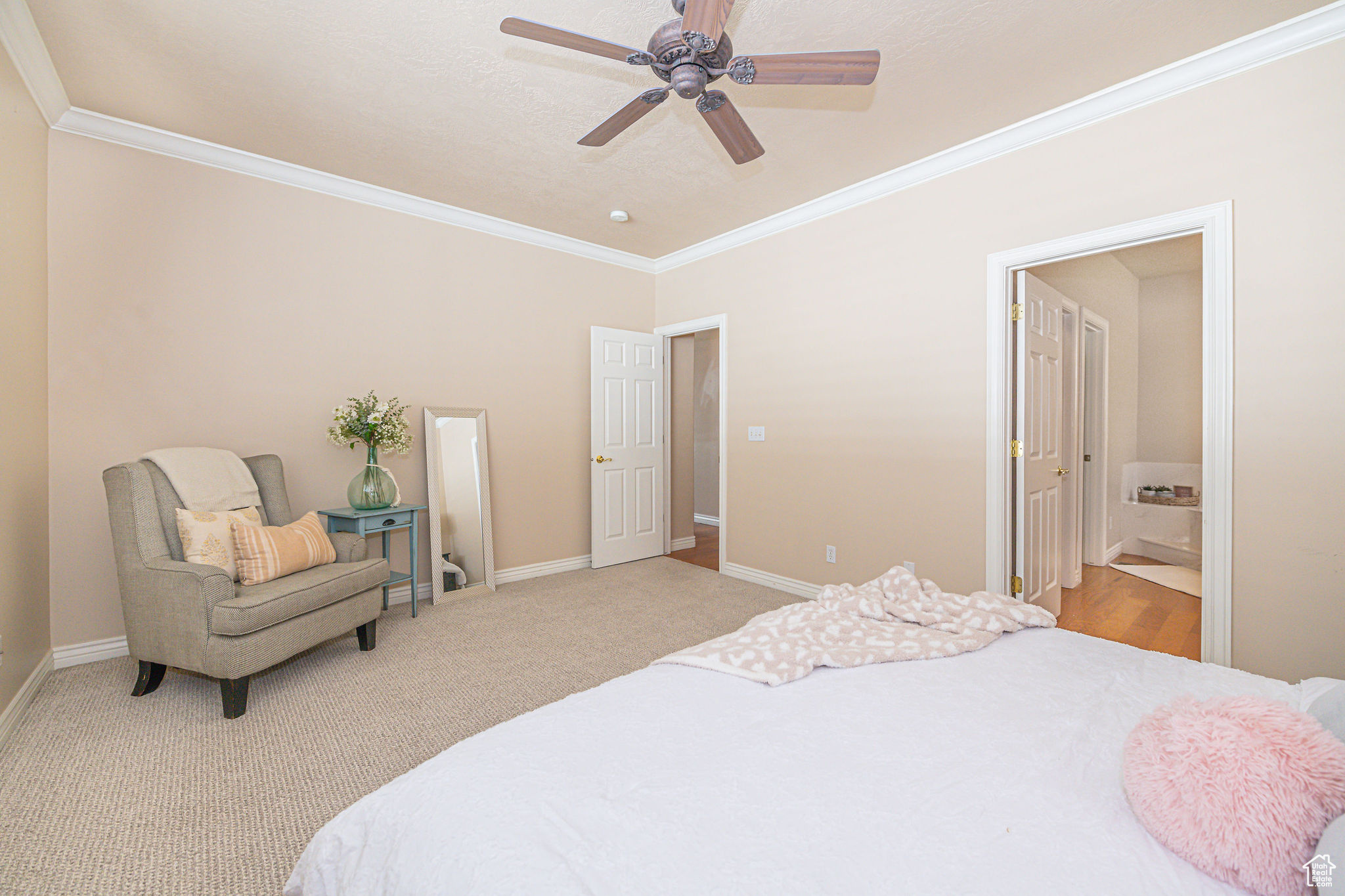 Bedroom featuring crown molding, light colored carpet, ceiling fan, and connected bathroom