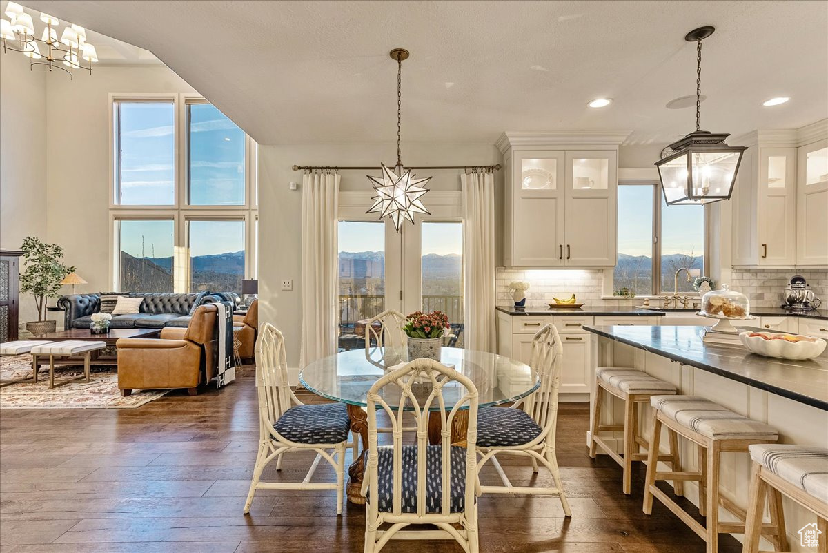 Dining room with a chandelier, a mountain view, engineered hardwood flooring, and sink