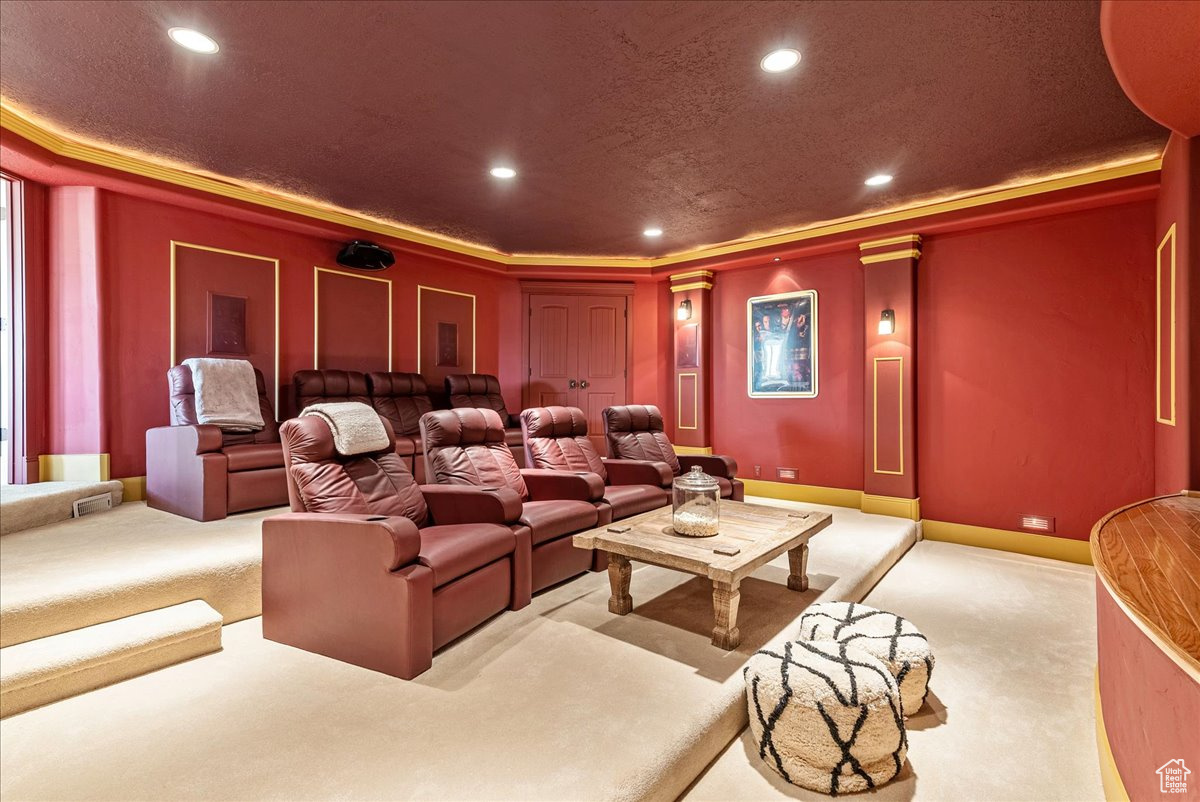 Home theater room featuring light carpet