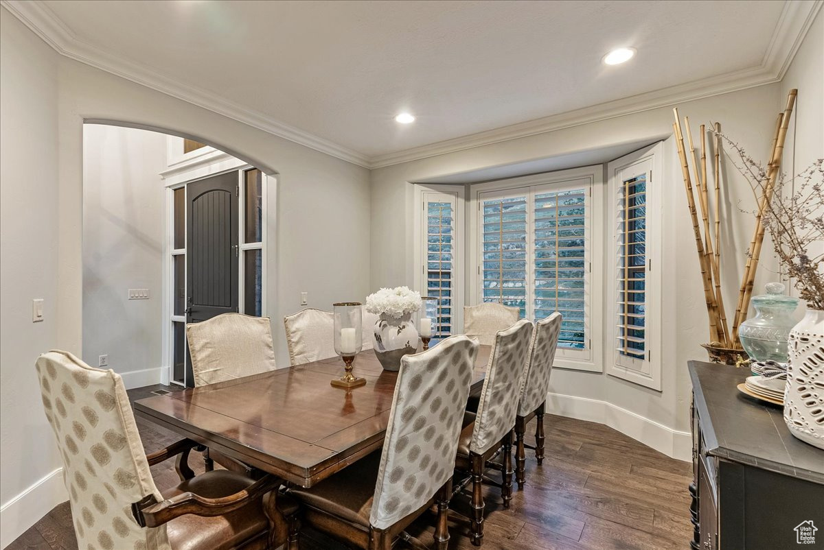 Dining space featuring ornamental molding and engineered hardwood flooring