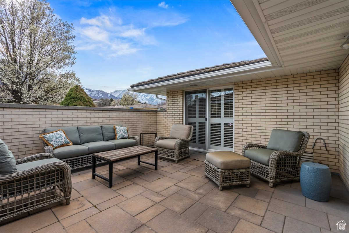 View of patio featuring outdoor lounge area and a mountain view