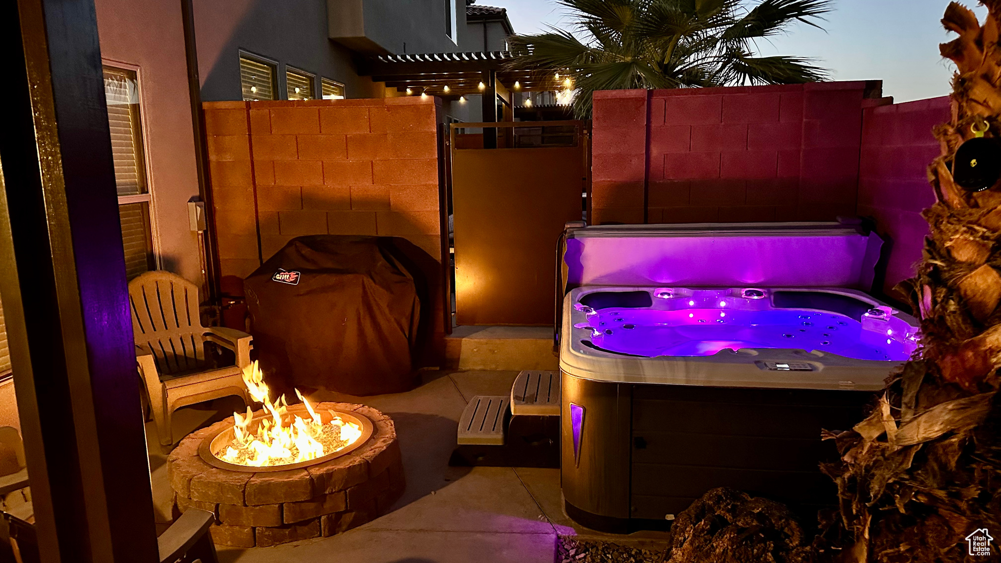 Exterior space featuring a hot tub and a fire pit