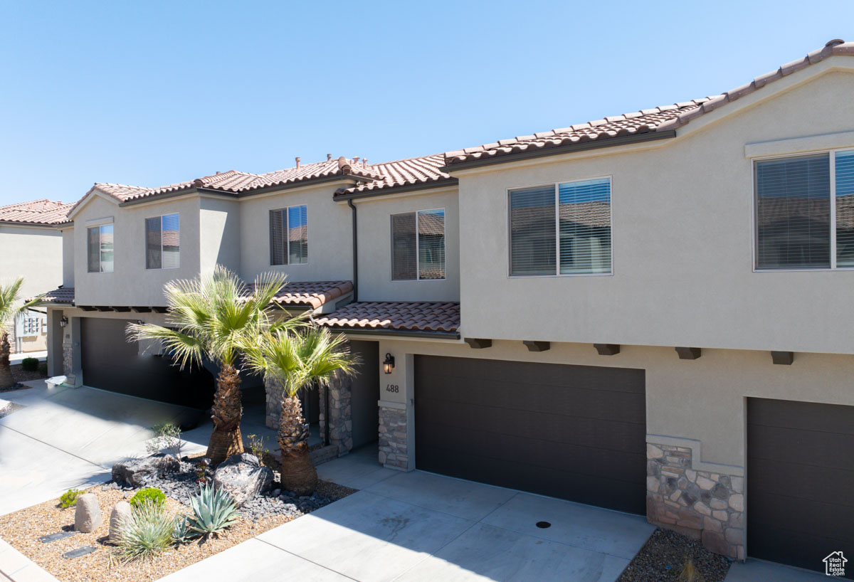 Mediterranean / spanish-style home featuring a garage