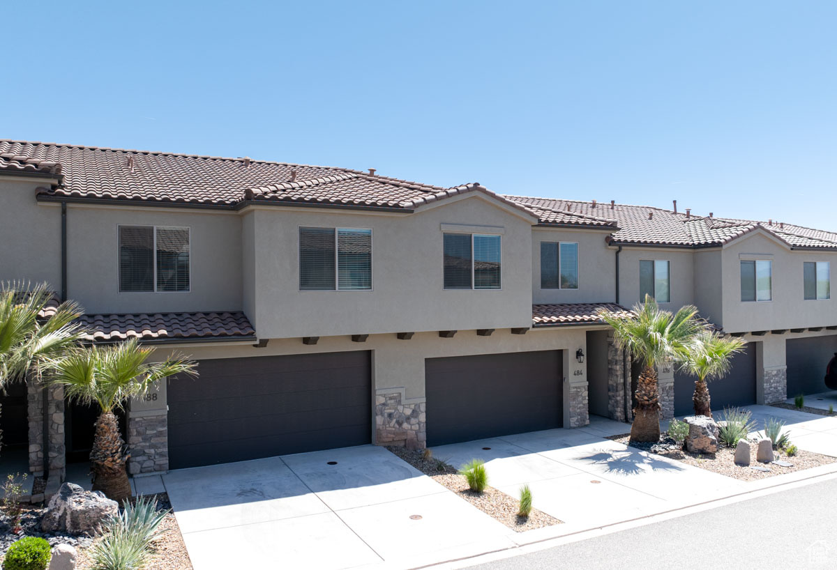 Mediterranean / spanish home with a garage