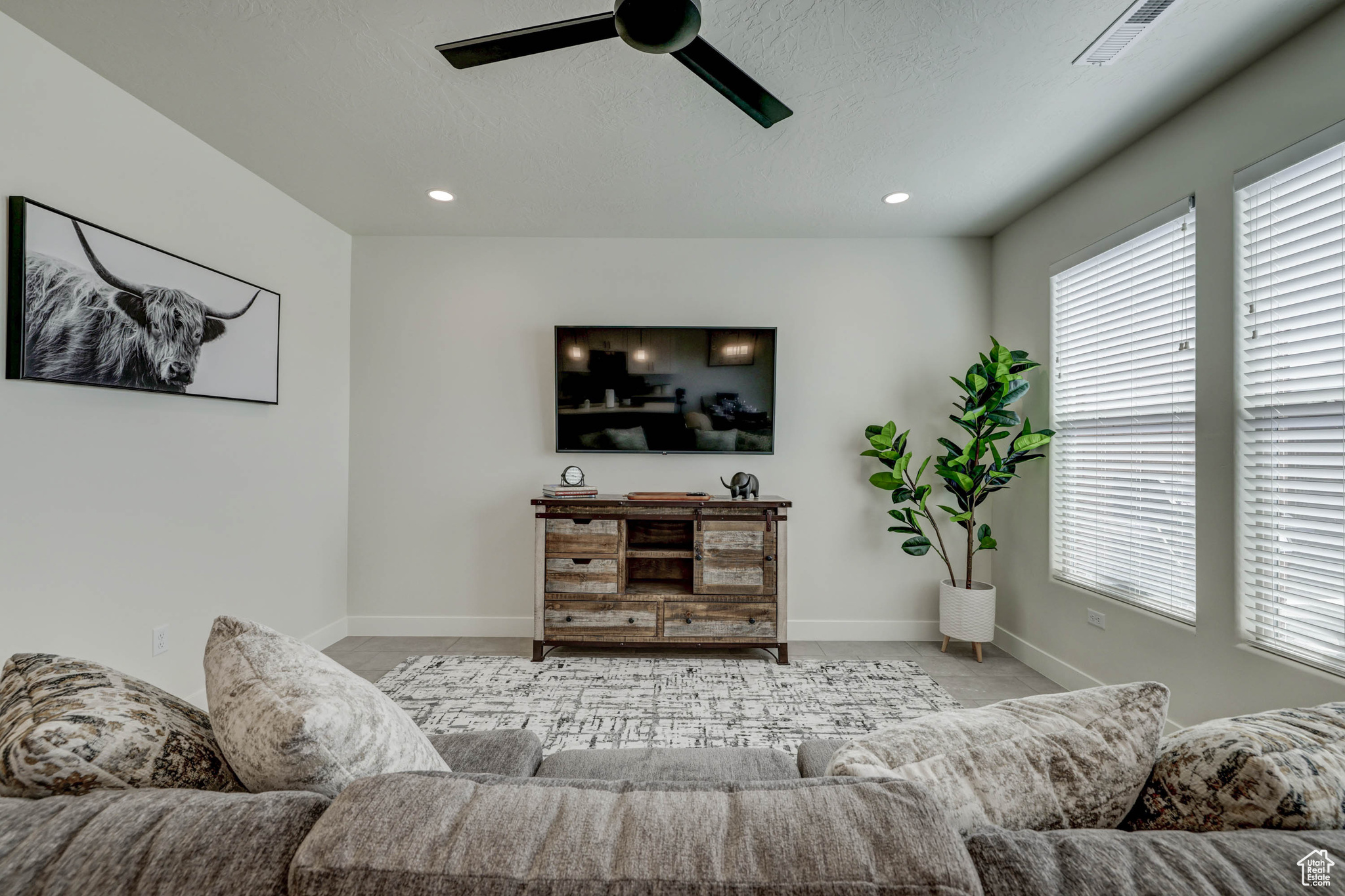 Living room featuring ceiling fan and a healthy amount of sunlight