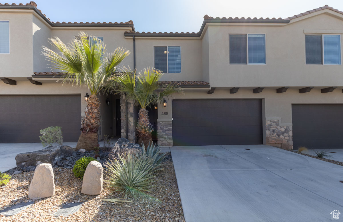 Mediterranean / spanish-style home featuring a garage