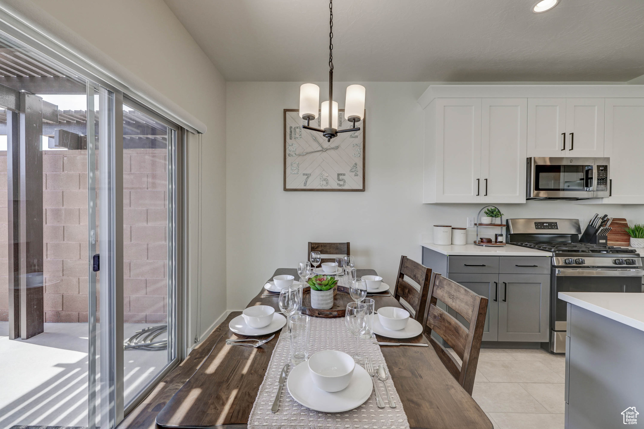 Tiled dining room featuring a notable chandelier