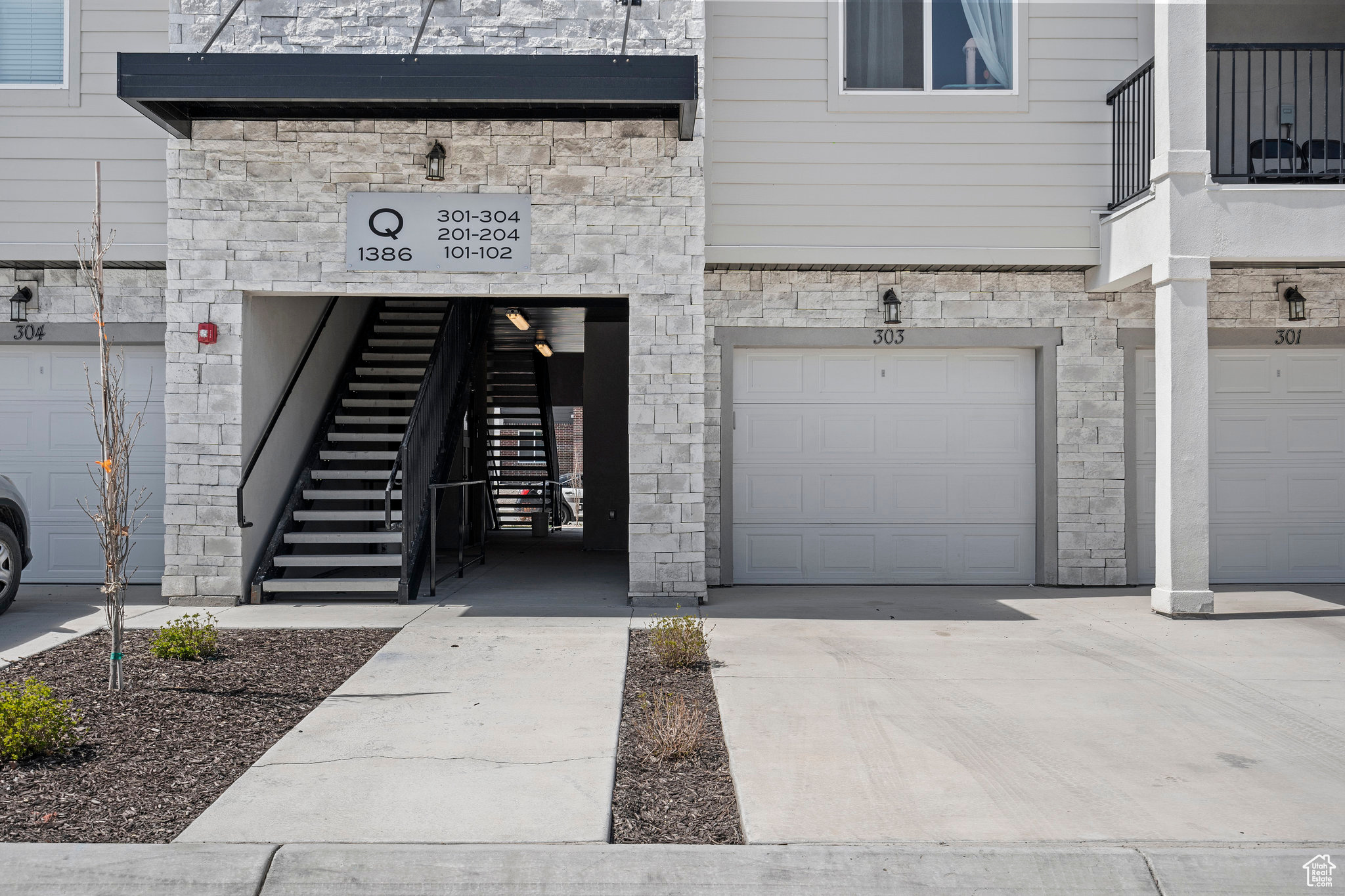 Entrance to property featuring a garage with pedestrian door to common area.