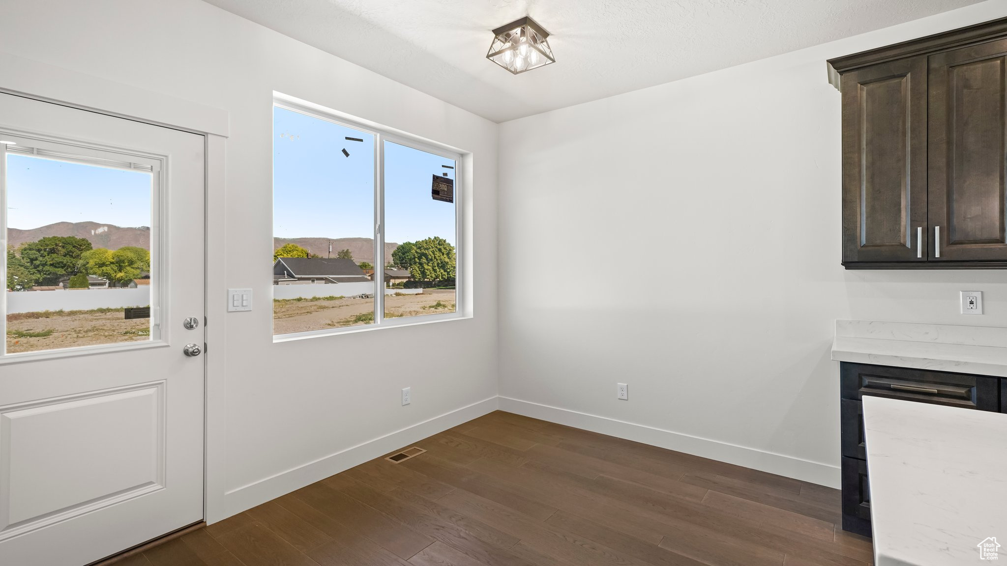 Dining area with dark wood-type flooring