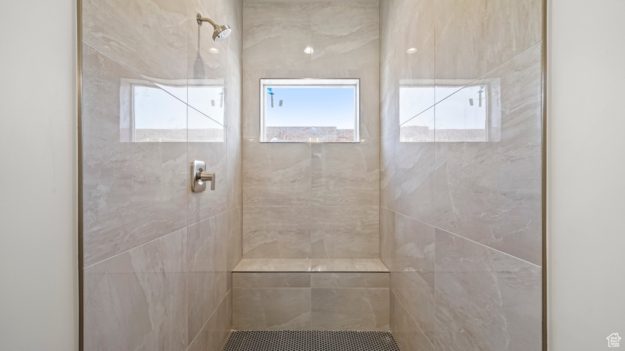 Bathroom featuring a tile shower