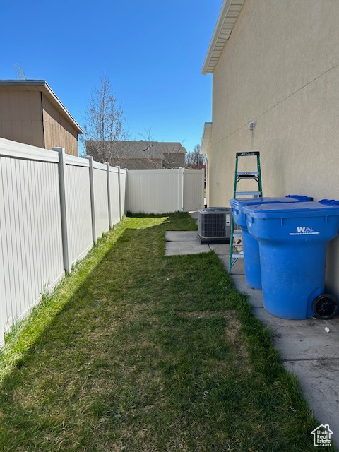 View of east side yard featuring central air condition unit