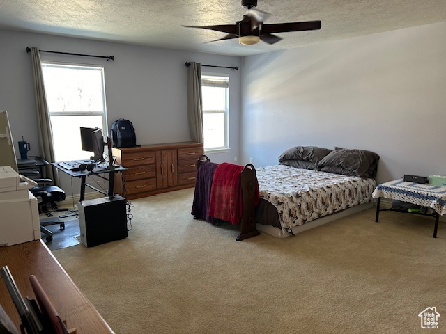 Master Bedroom with light colored carpet, ceiling fan, and a textured ceiling