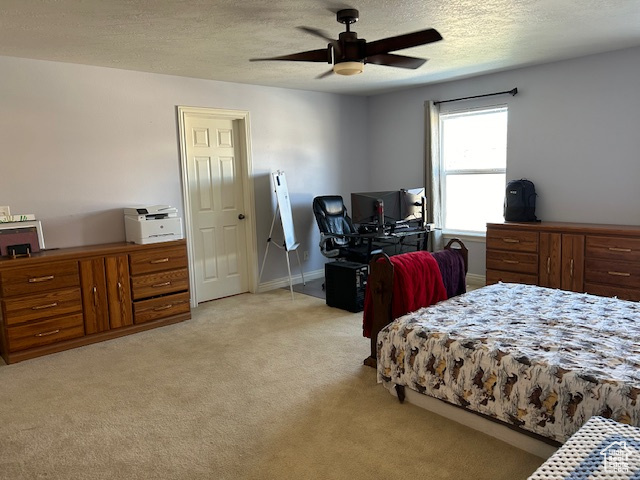 Master Bedroom featuring a textured ceiling, ceiling fan, and light carpet