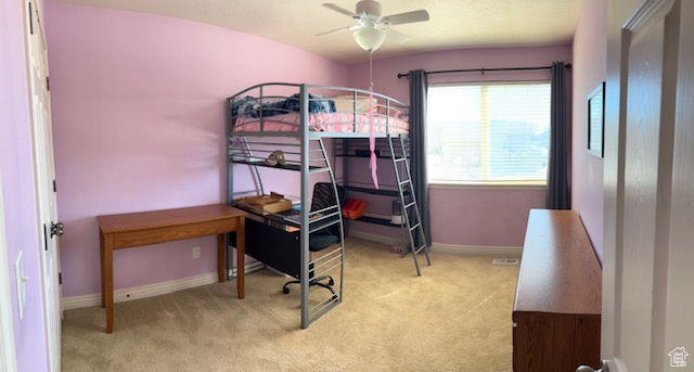 Carpeted bedroom with ceiling fan