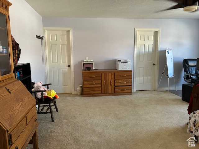 Master Bedroom featuring light colored carpet, ceiling fan, and a textured ceiling