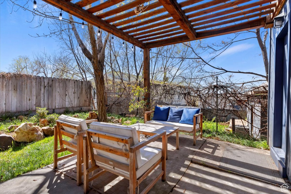 View of patio with an outdoor living space and a pergola