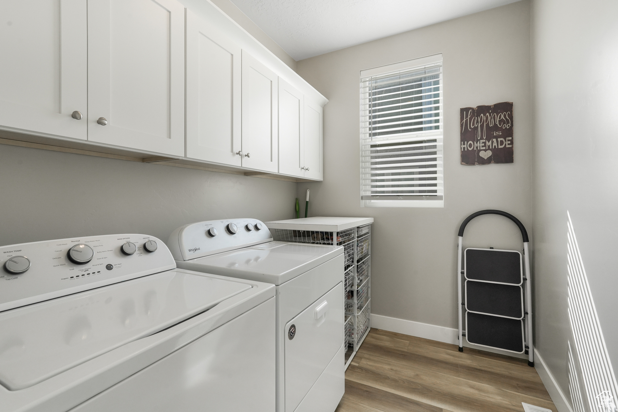 Large laundry room with lots of built in cabinets
