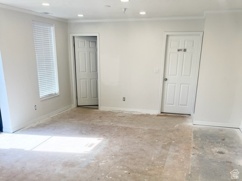 Empty room featuring ornamental molding