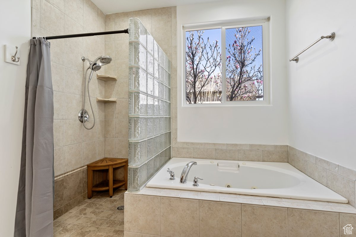 Bathroom featuring plus walk in shower and tile flooring