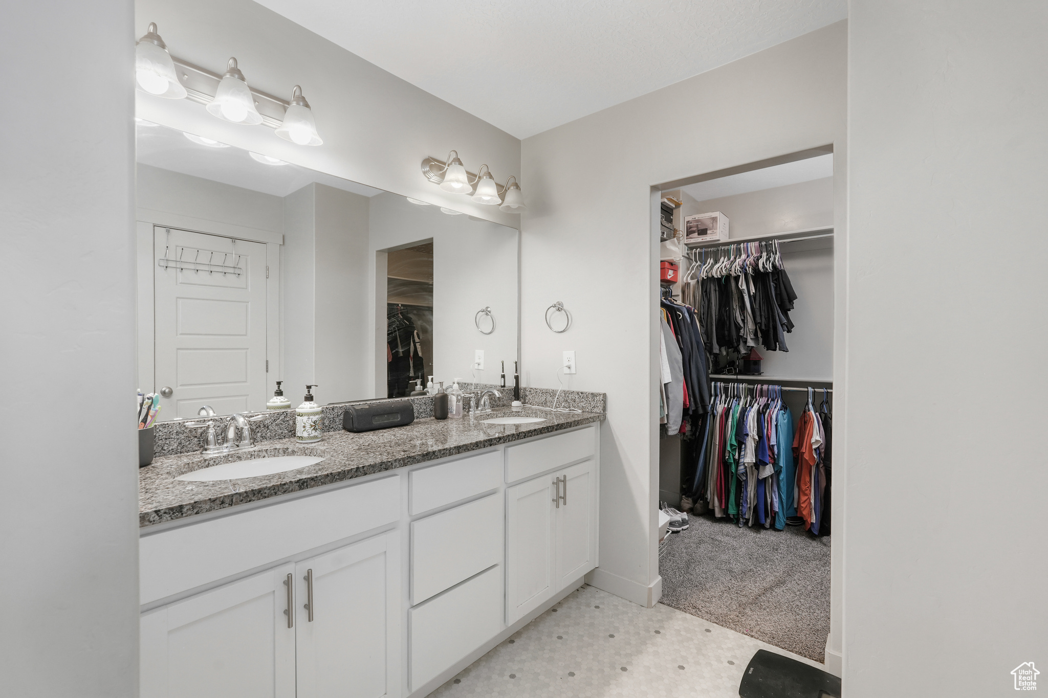 Master bathroom with double vanity and walk in closet