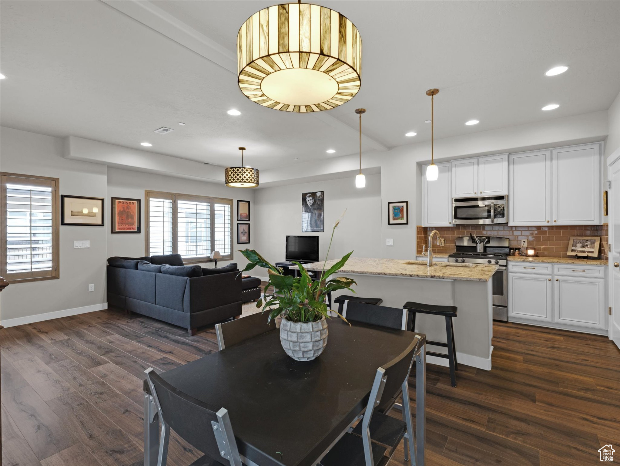 Dining space featuring sink and dark hardwood / wood-style flooring