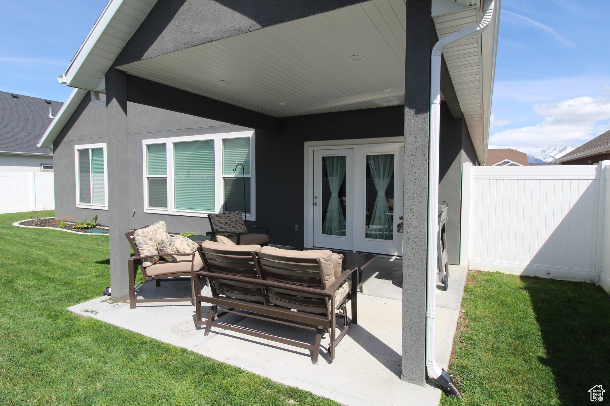 View of covered patio featuring grilling area and an outdoor hangout area