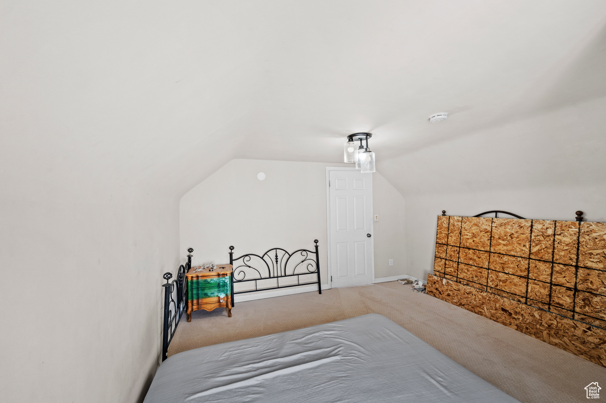 Bedroom with lofted ceiling and carpet flooring