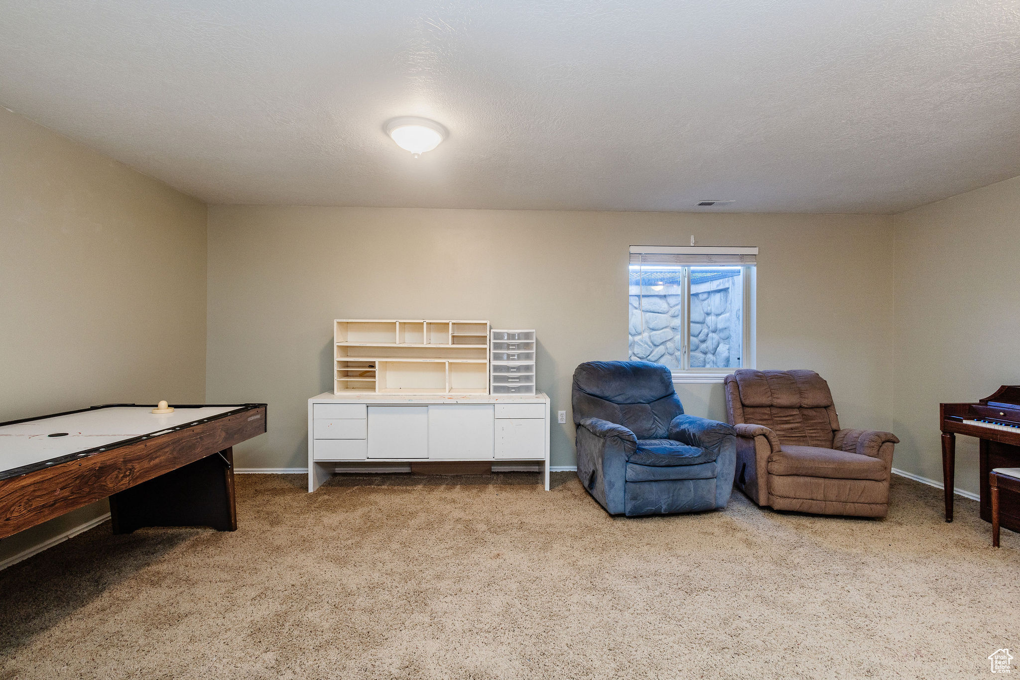 Large family room with light colored carpet. Lots of room for multi-use.