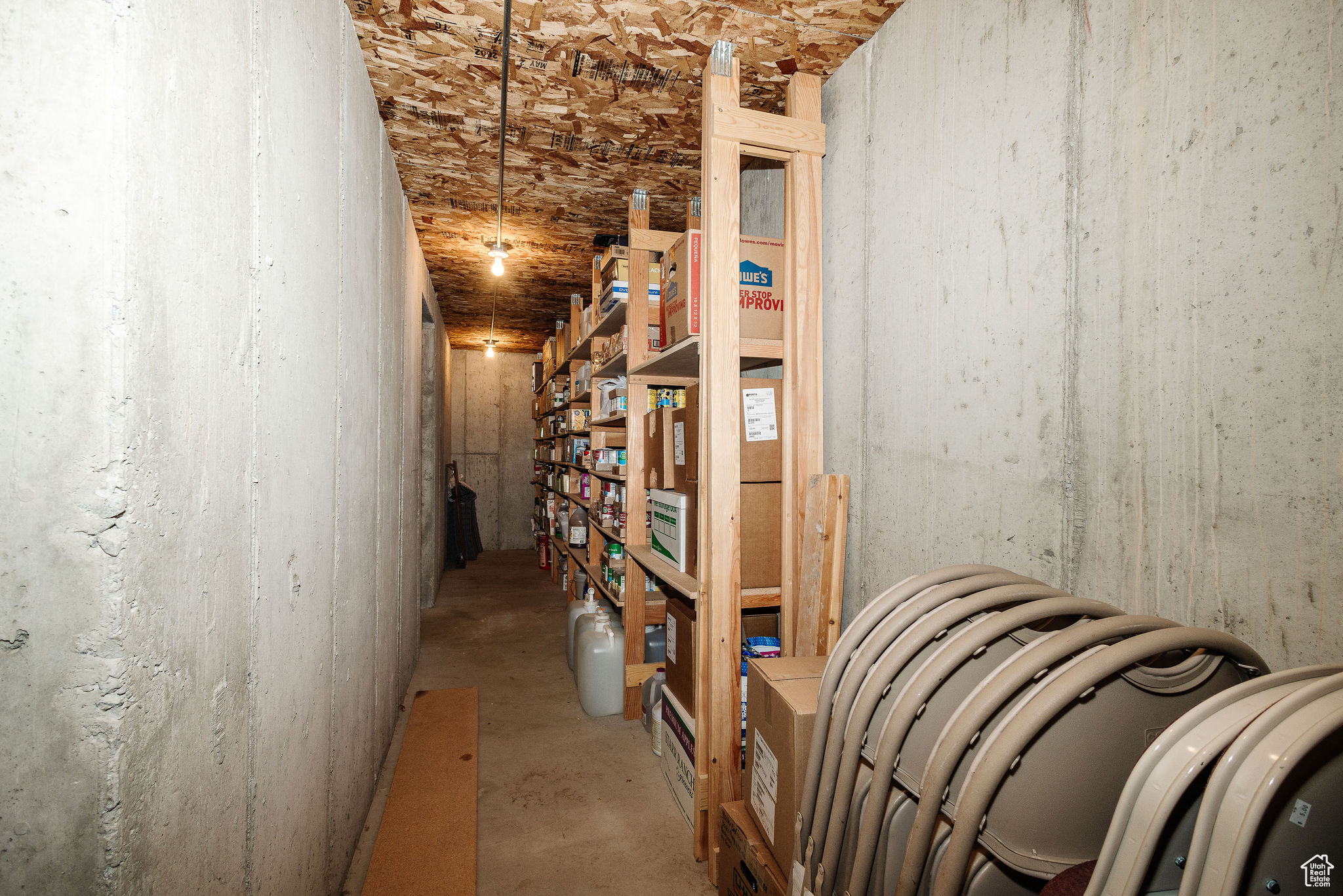 View of storage room with anchored/built shelving for storage.  Cool tempature for storage.