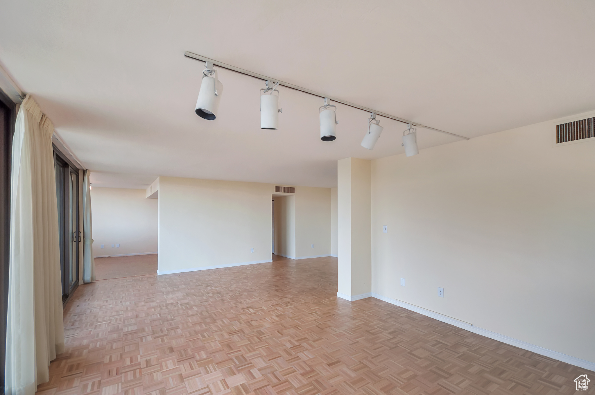 Unfurnished room with light parquet flooring