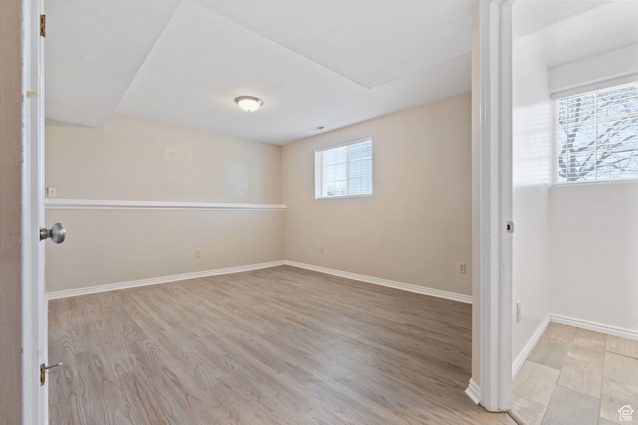 Spare room with a healthy amount of sunlight and light hardwood / wood-style floors