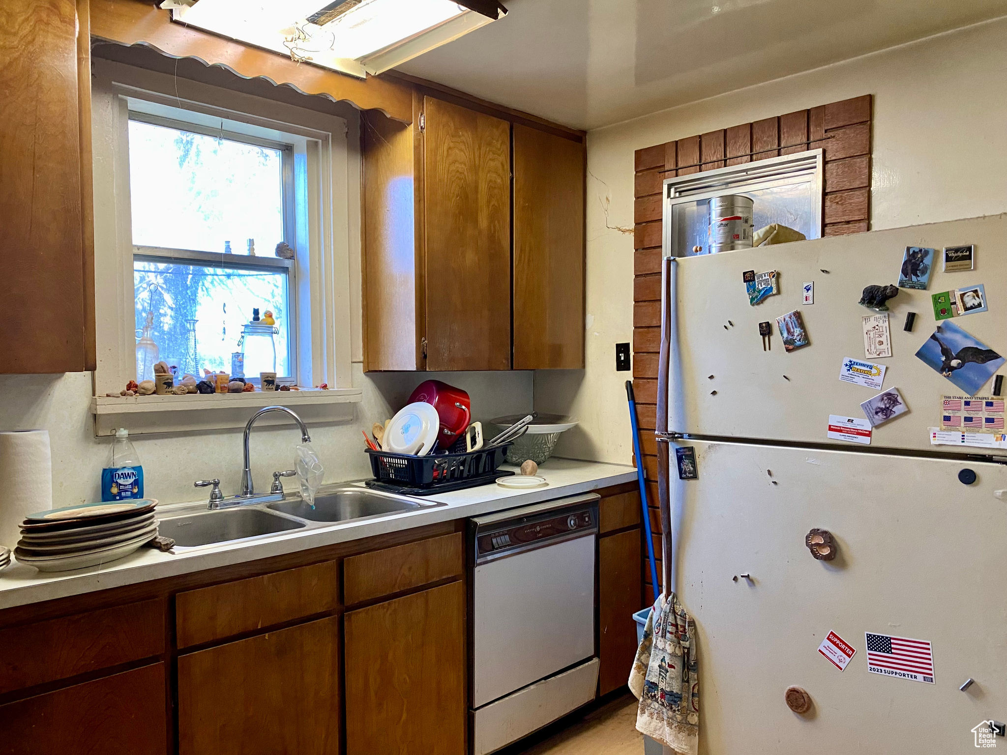 Kitchen with white appliances and sink