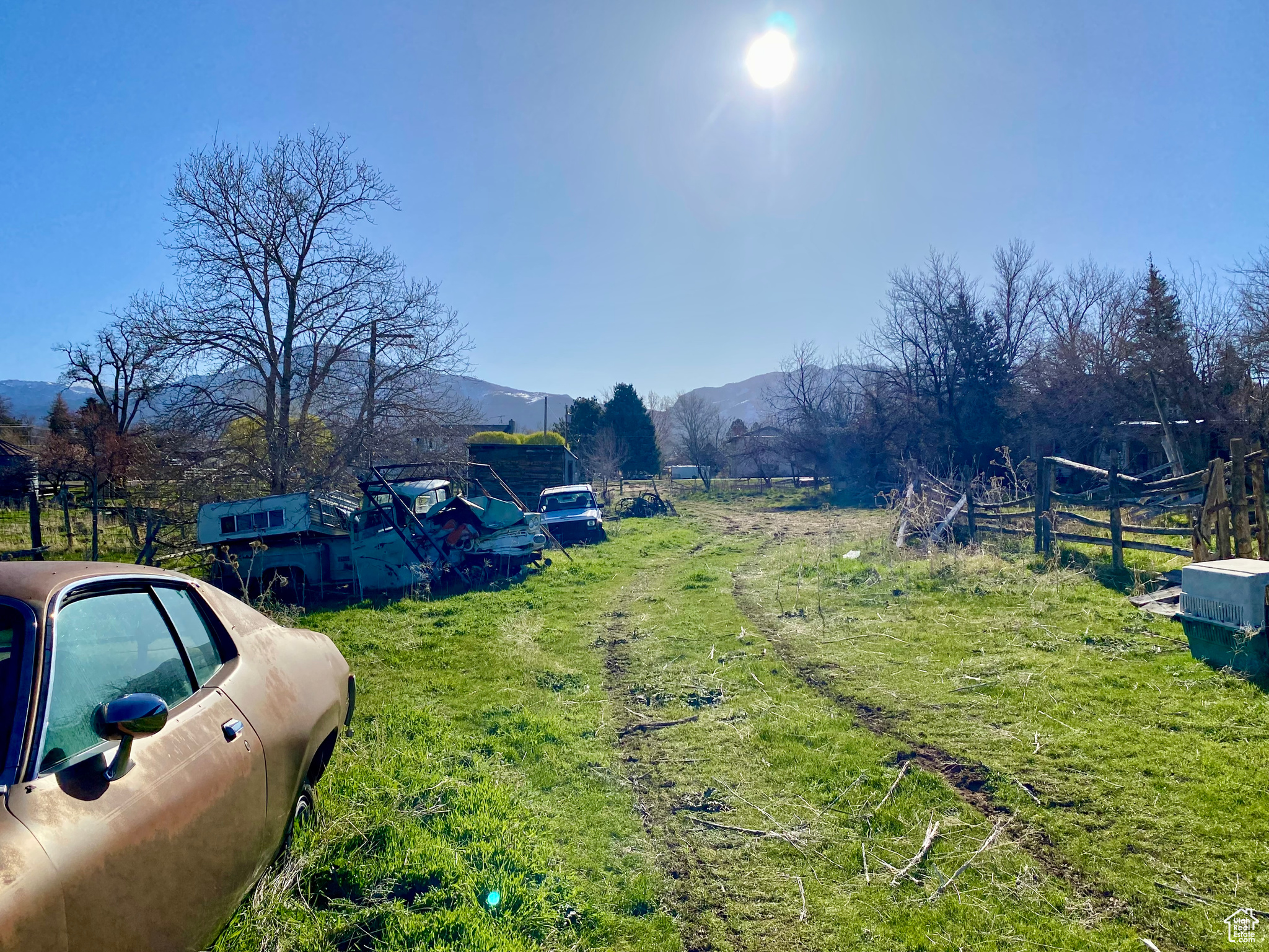 View of yard with a rural view and a mountain view