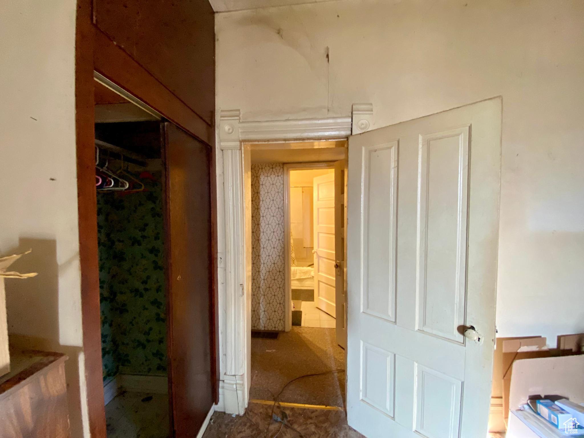 Corridor featuring dark tile floors