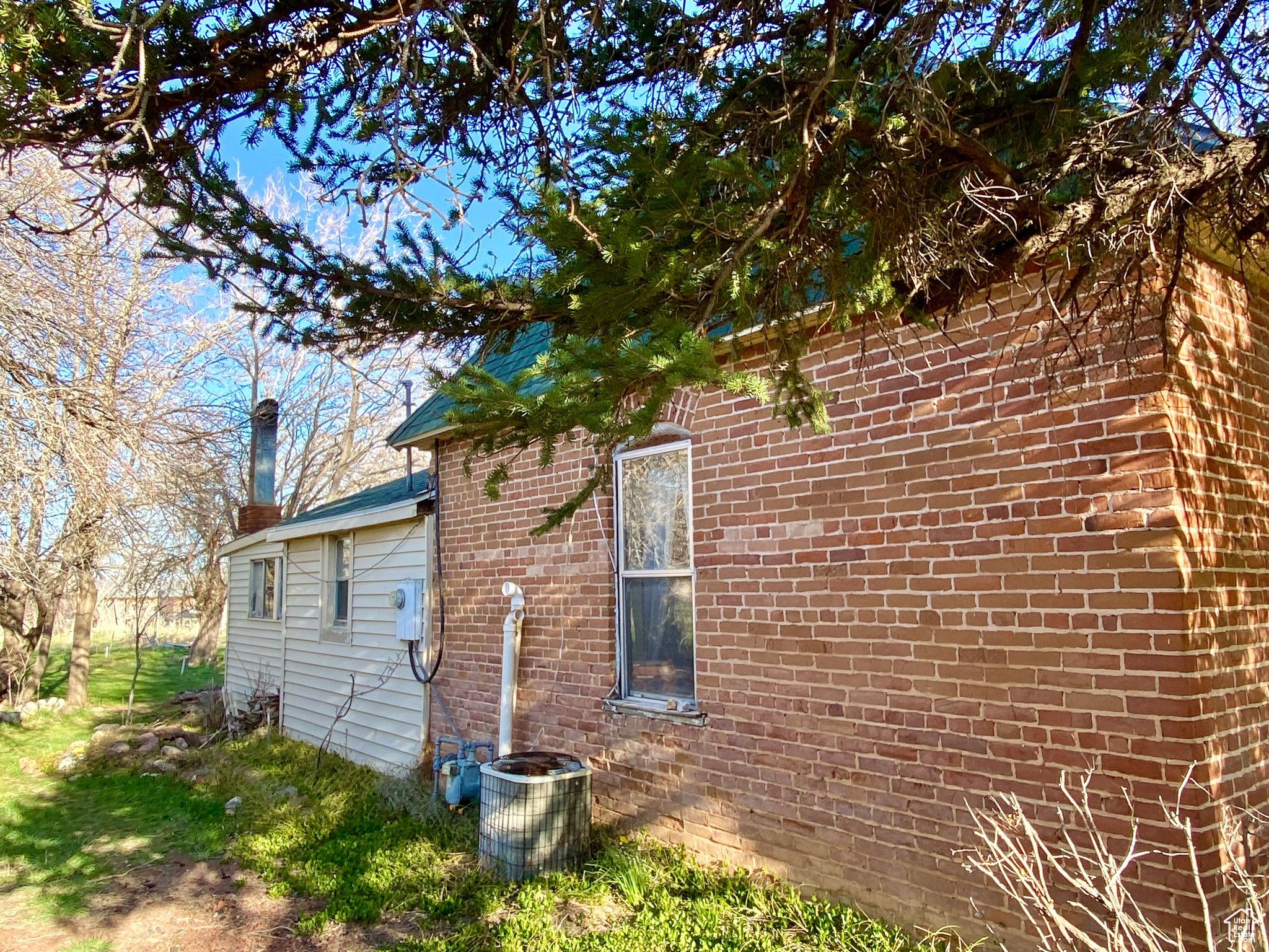 View of side of property with central AC