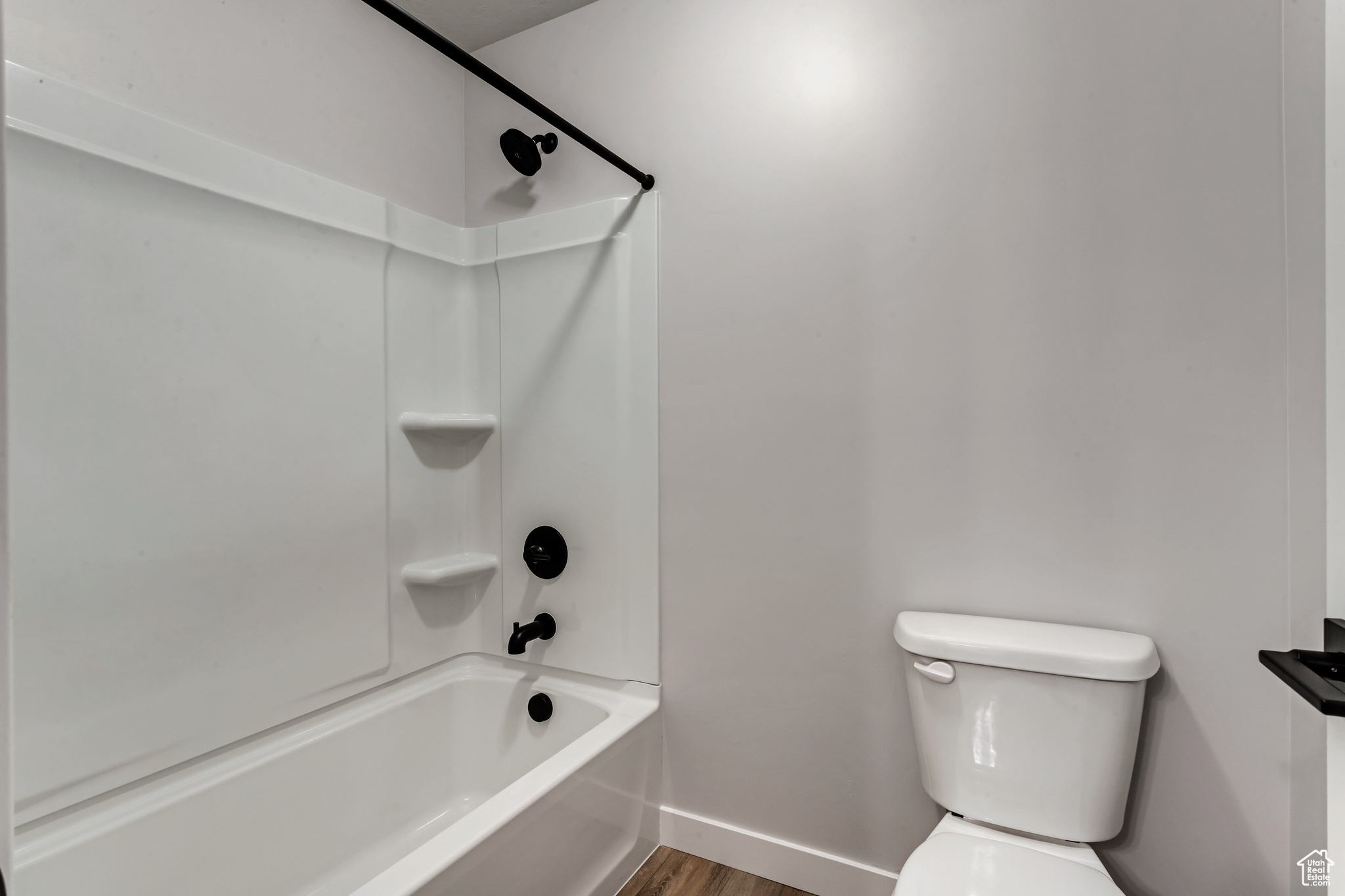 PHOTOS FROM A SIMILAR HOME. COLORS AND SELECTIONS WILL VARY.  Bathroom 2 featuring  shower combination, hardwood / wood-style flooring, and toilet