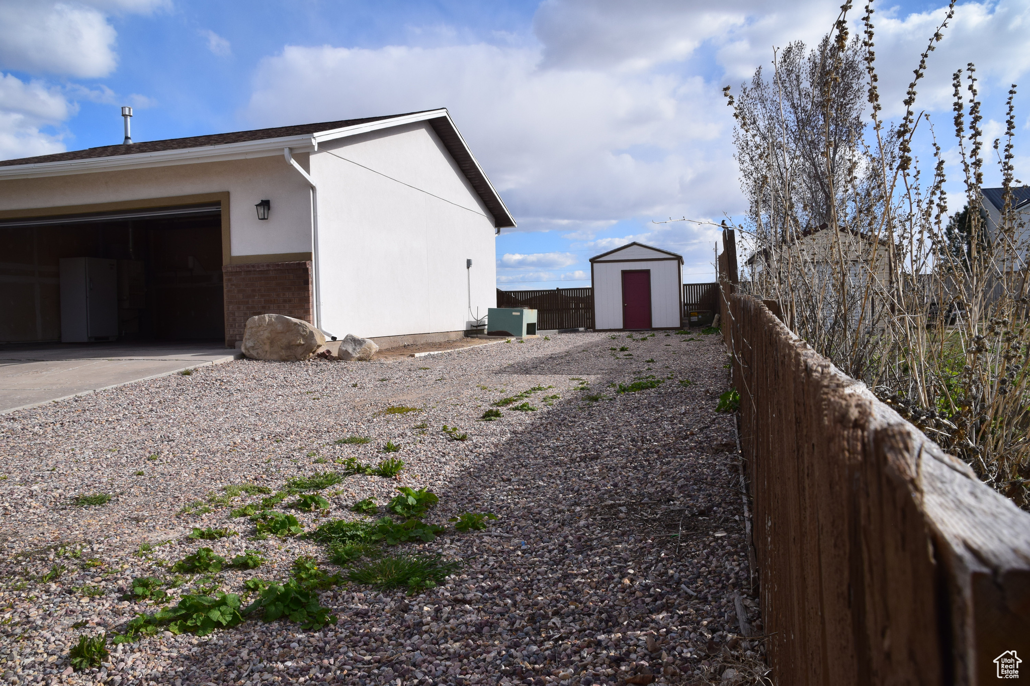 View of yard with a garage and a storage shed