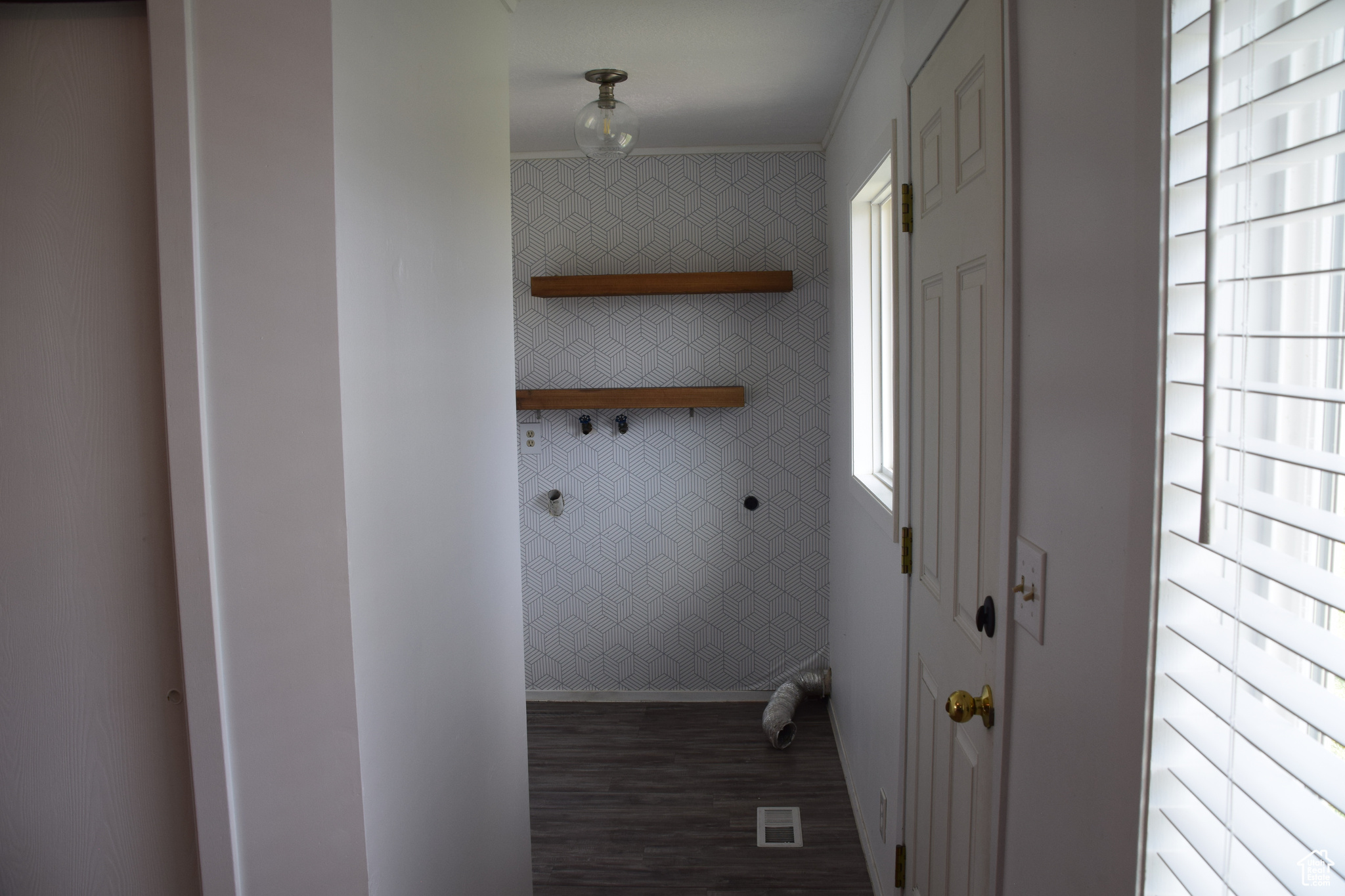 Washroom with dark hardwood / wood-style flooring