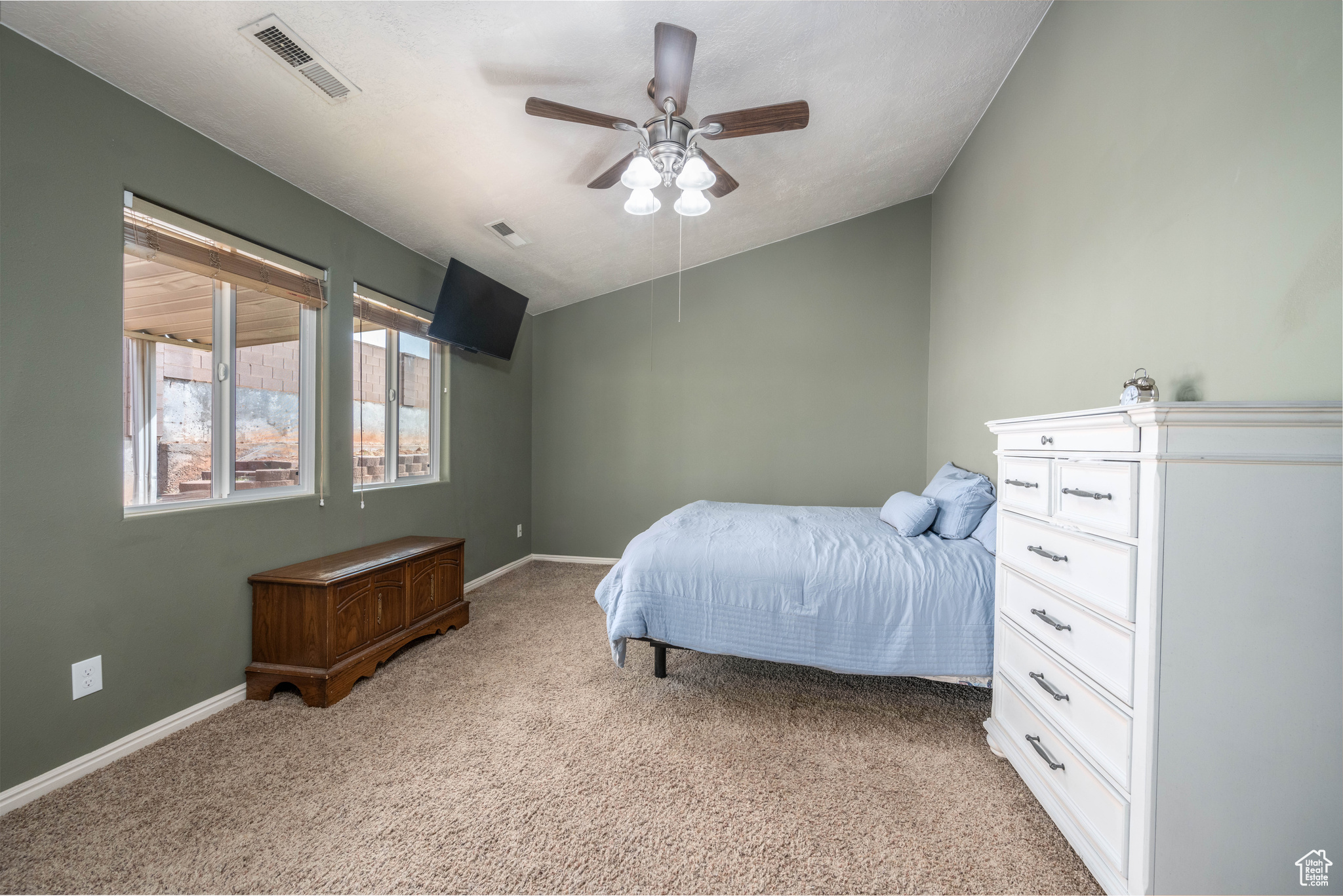 Bedroom with light carpet and ceiling fan