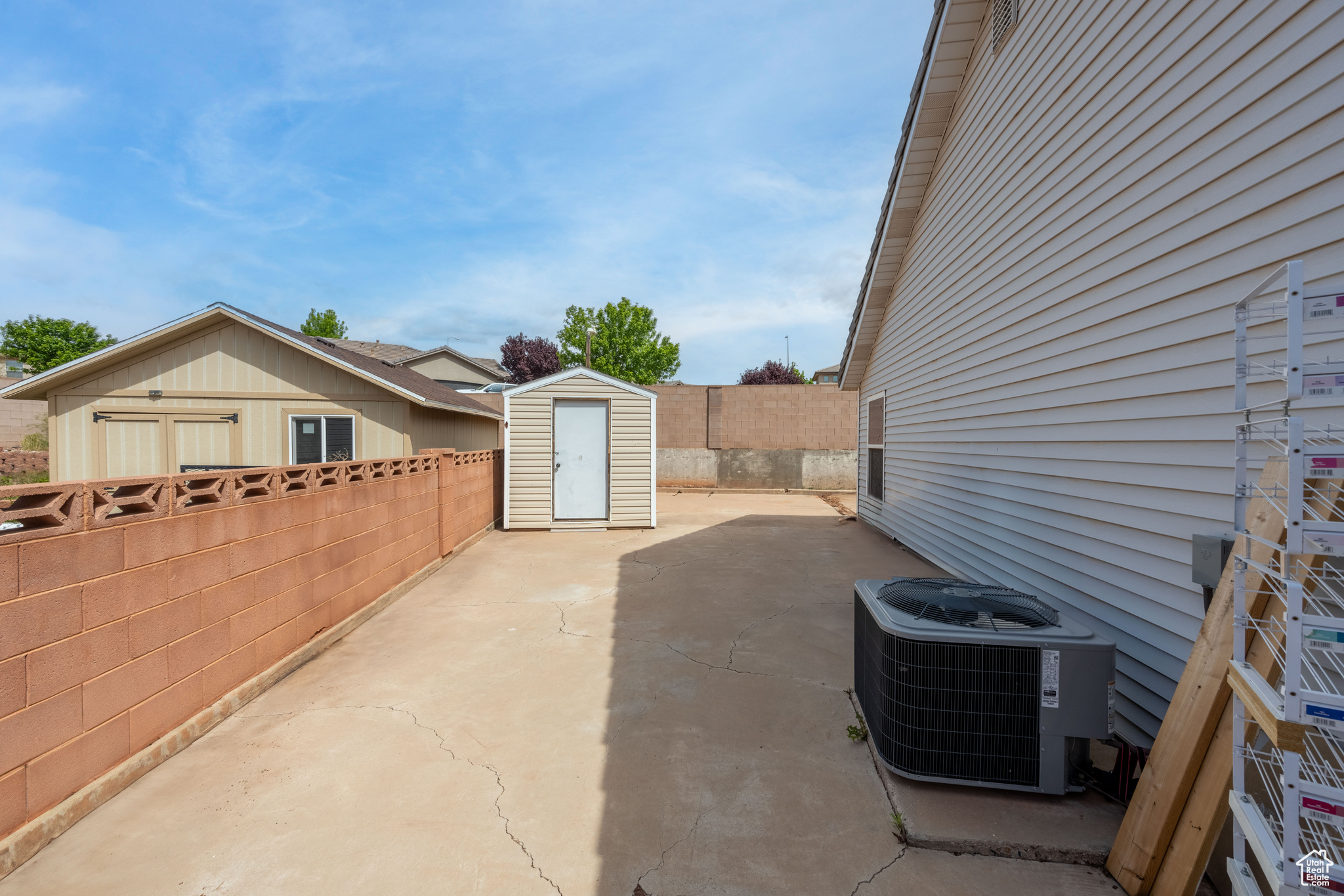 View of patio / terrace featuring central AC unit and a storage shed