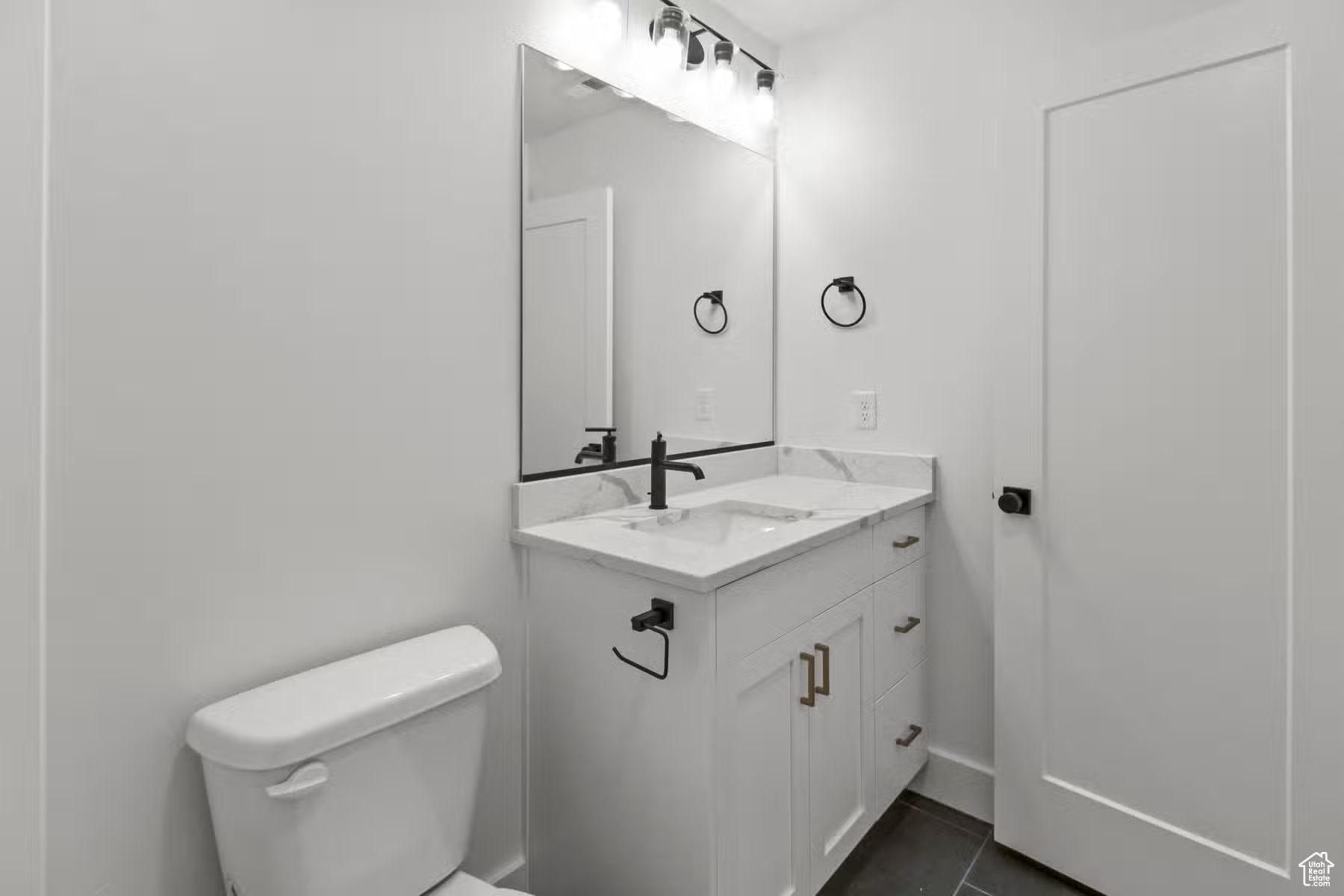 Bathroom with tile floors, toilet, and large vanity