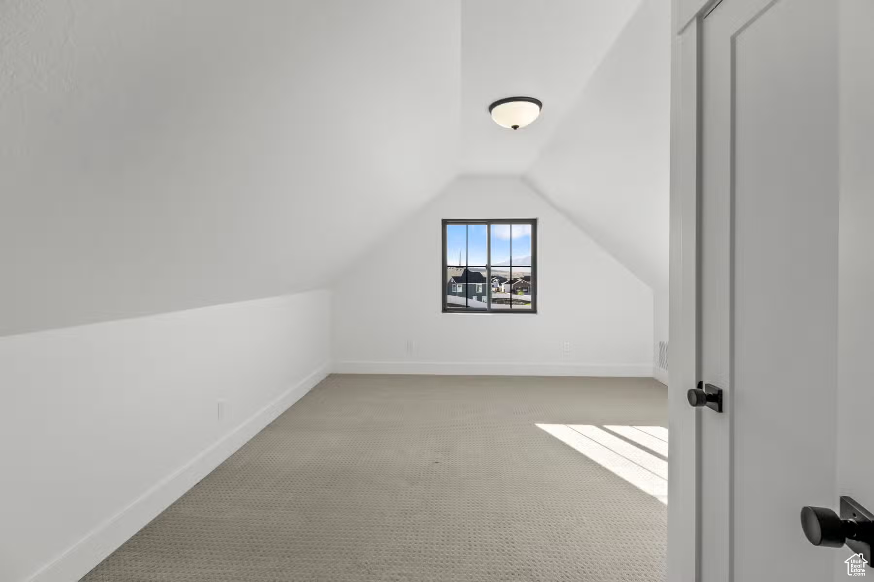 Bonus room with light carpet and lofted ceiling