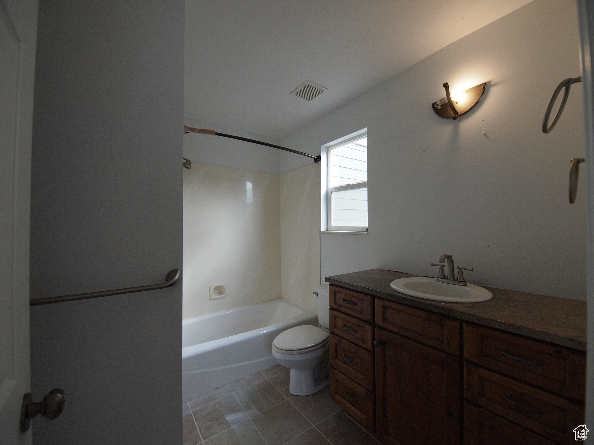 Upstairs  full primary bathroom with tile floors, tub / shower combination, vanity, and toilet