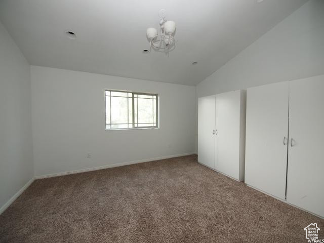 Lower level bedroom with double closets, carpet, and vaulted ceiling