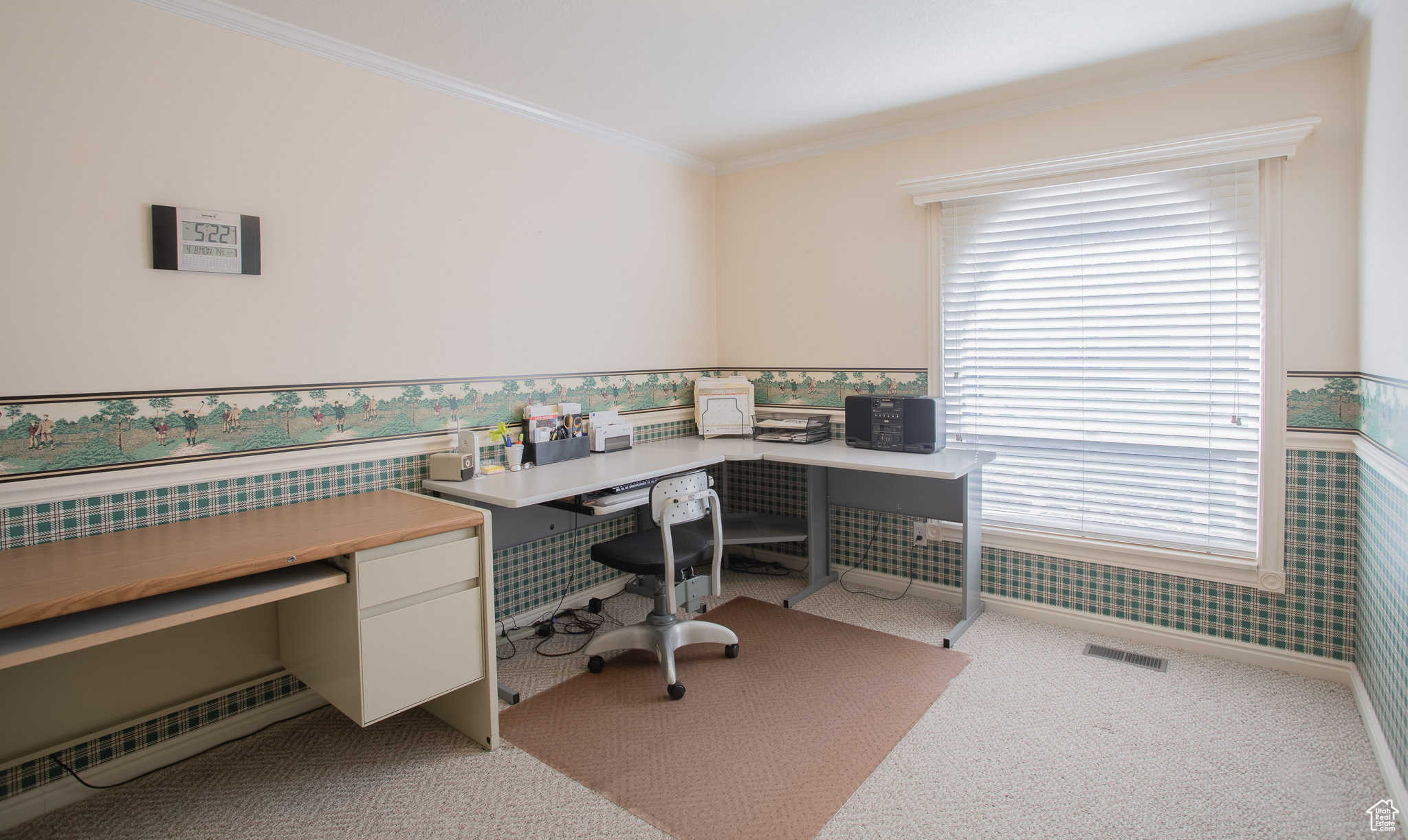 Carpeted office space with a healthy amount of sunlight and crown molding