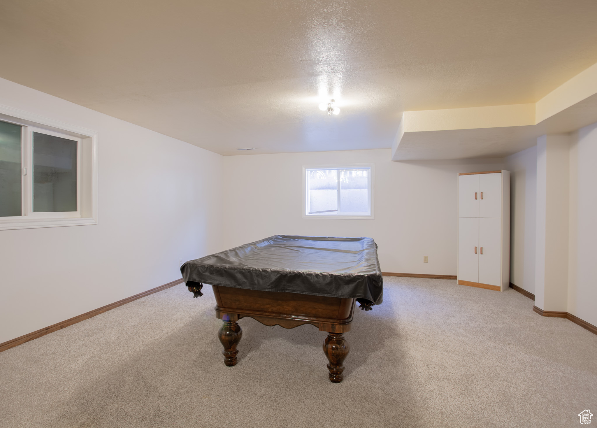 Game room with light colored carpet and pool table