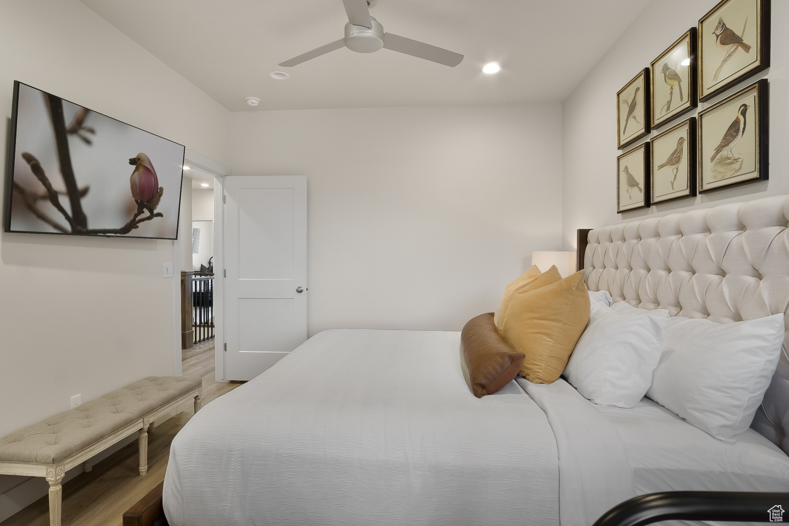 Bedroom with hardwood / wood-style floors and ceiling fan