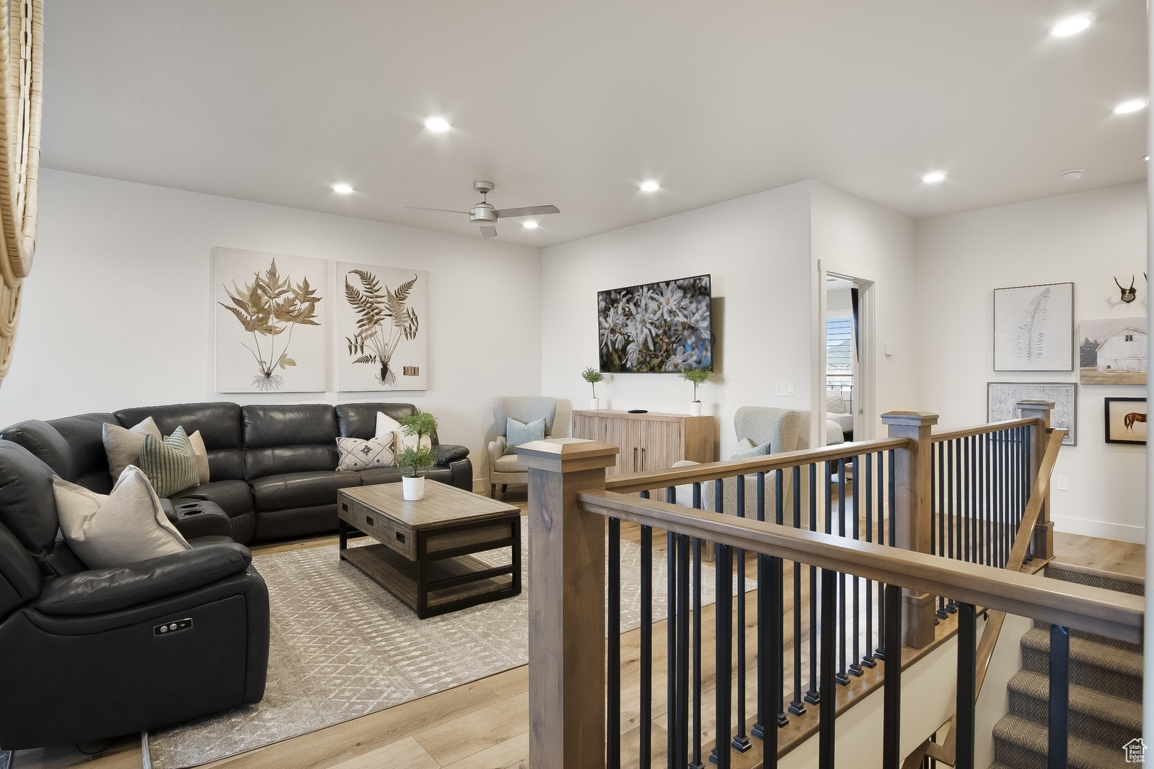 Living room featuring light hardwood / wood-style floors and ceiling fan